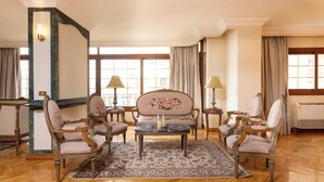 A room with a large window, a fireplace, and a chandelier. - Kennah Lascaic | 3BR Near Korba & Metro, Heliopolis (Cairo)