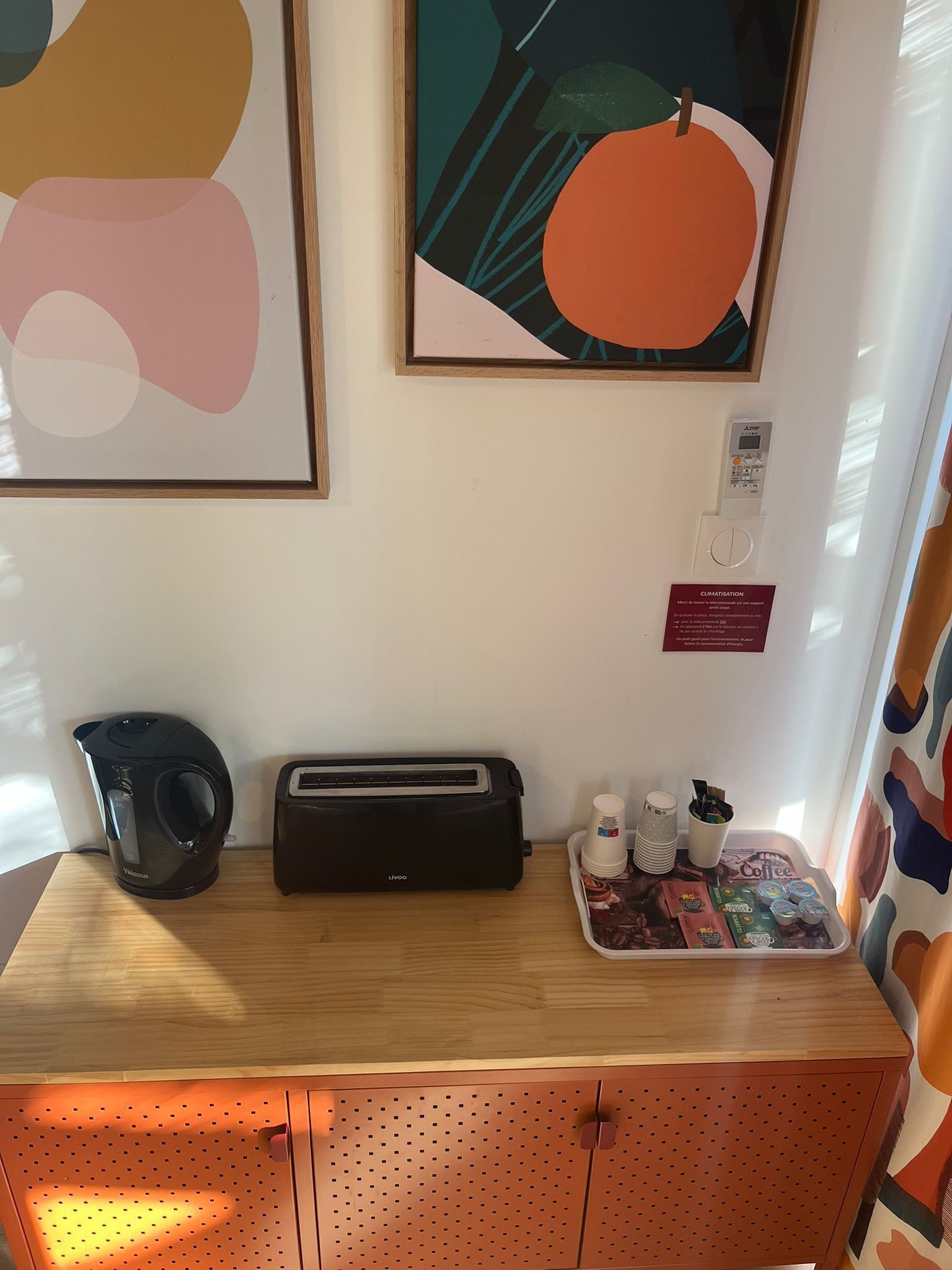 A kitchenette with a kettle, toaster, and coffee station.