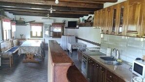 Une cuisine rustique avec des meubles en bois, un long comptoir et un four encastré.