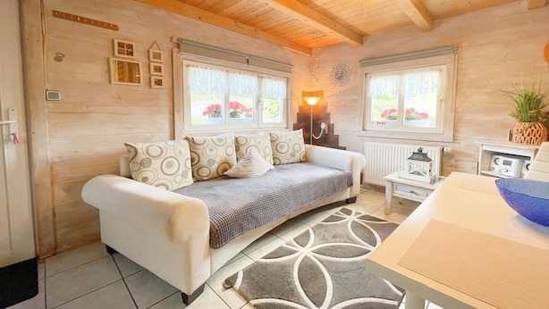 A cozy room with a sofa, a small table, and a decorative lamp.