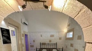 A room with a bed, a door, and a small window.