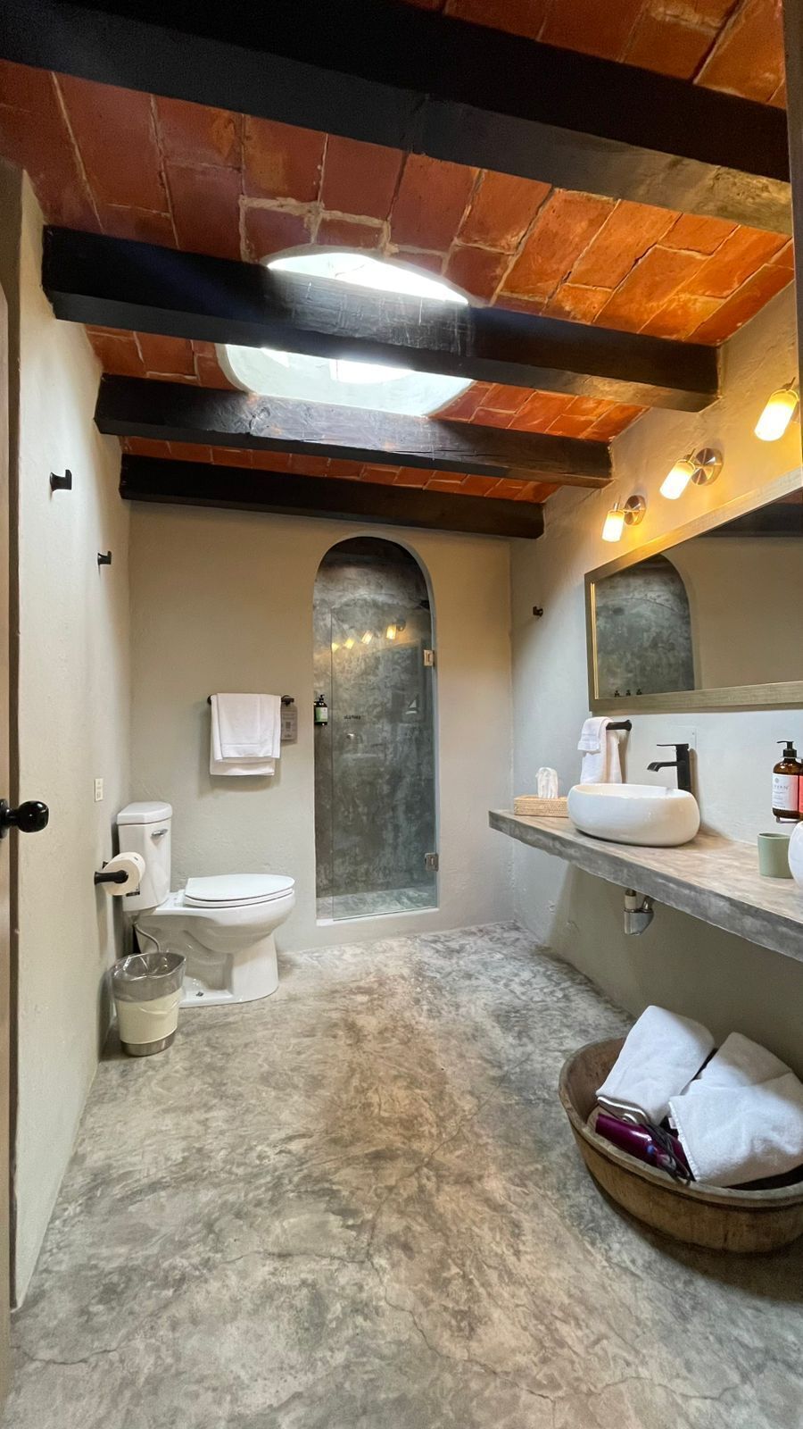 A bathroom with a toilet, sink, and shower.