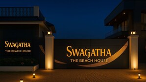 A modern building with the name "Swagatha The Beach House" illuminated on its facade. - Swagatha The Beach House ECR (Kanchipuram District,ECR 603104)