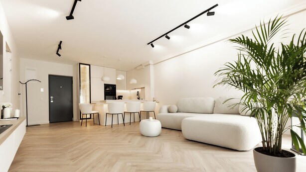 A modern living room with a sofa, dining area, and a large potted plant. - Nest Inn Boucle Apartment (Baia Mare)
