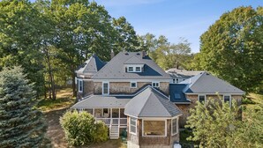 A large brick house with multiple sections, including a covered porch and a small gazebo. - Historic Charm Meets Modern Luxury in Kennebunkport|Walk to Shops & Restaurants! (Kennebunkport)