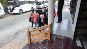 A bus stop with a bench and a tiled floor. - Hotel Rest and Bite (Rajgarhi)