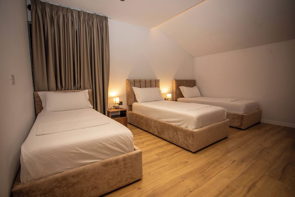 Deluxe Triple Room, City View | In-room safe, desk, laptop workspace, iron/ironing board