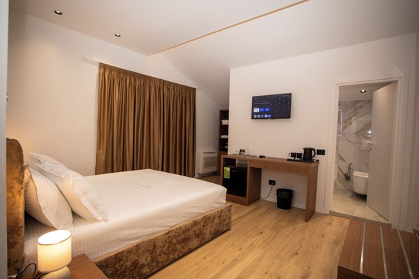 Deluxe Double Room, City View | In-room safe, desk, laptop workspace, iron/ironing board