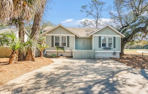 A two-story house with a front yard, a driveway, and a mailbox.