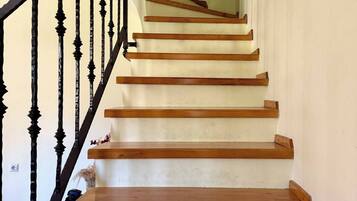 A staircase with wooden steps and black balusters.