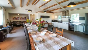 A modern kitchen with white cabinets and a stainless steel range hood. - 3 bedroom lovely home in Beesel (Beesel)