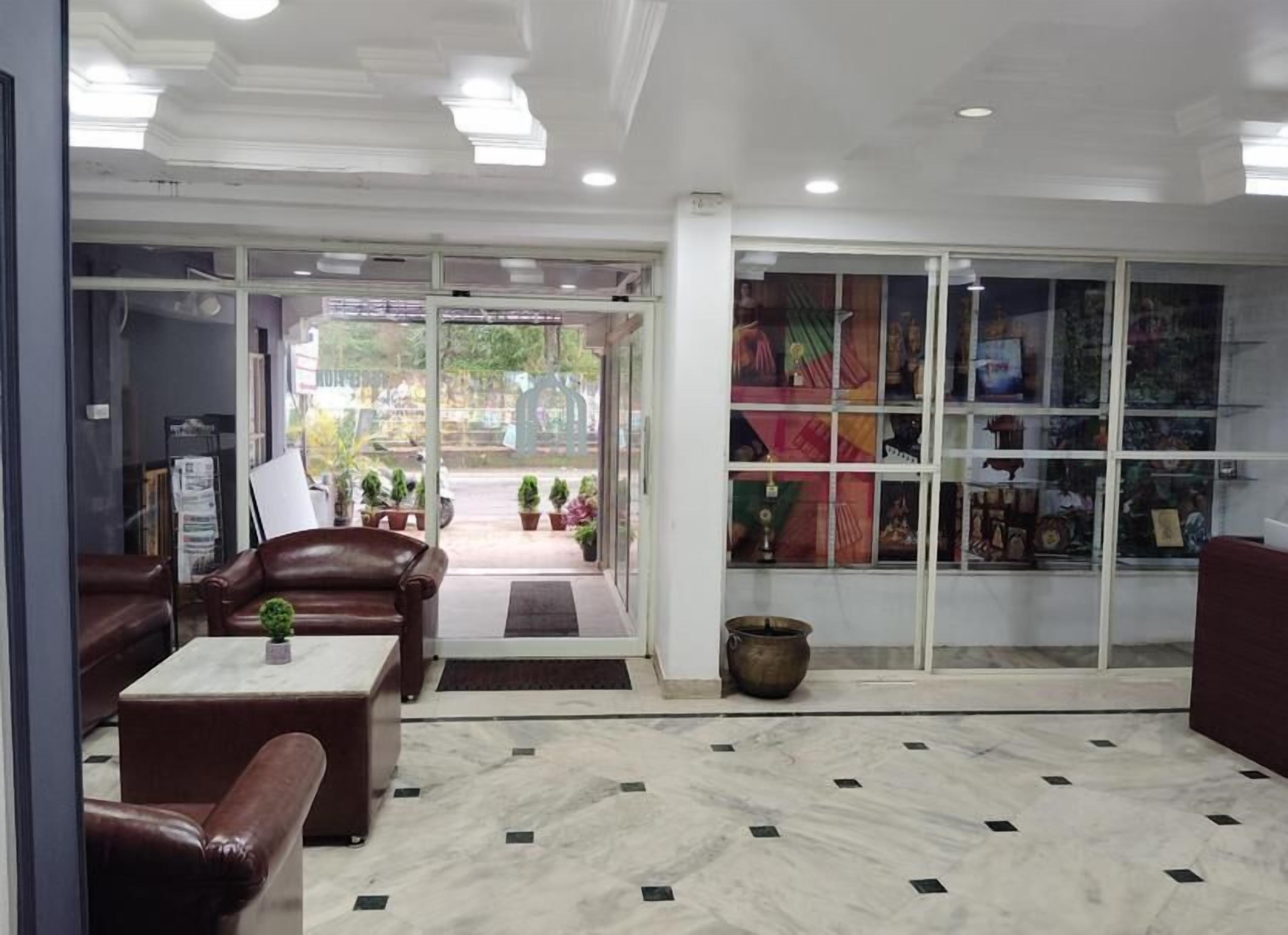A lobby with seating, a reception desk, and a display of items.