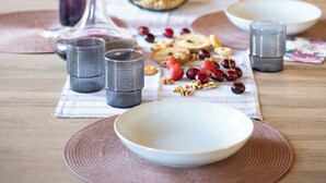 A breakfast table with plates, glasses, and a bowl of fruit. - La Loggetta, a refuge in the heart of authentic Tuscany (colle di val d'elsa)