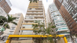 A multi-story building with balconies, a yellow awning, and a sign reading "seazone." - Studio With Balcony 500m From the Metro - Mop0103 (São Paulo)