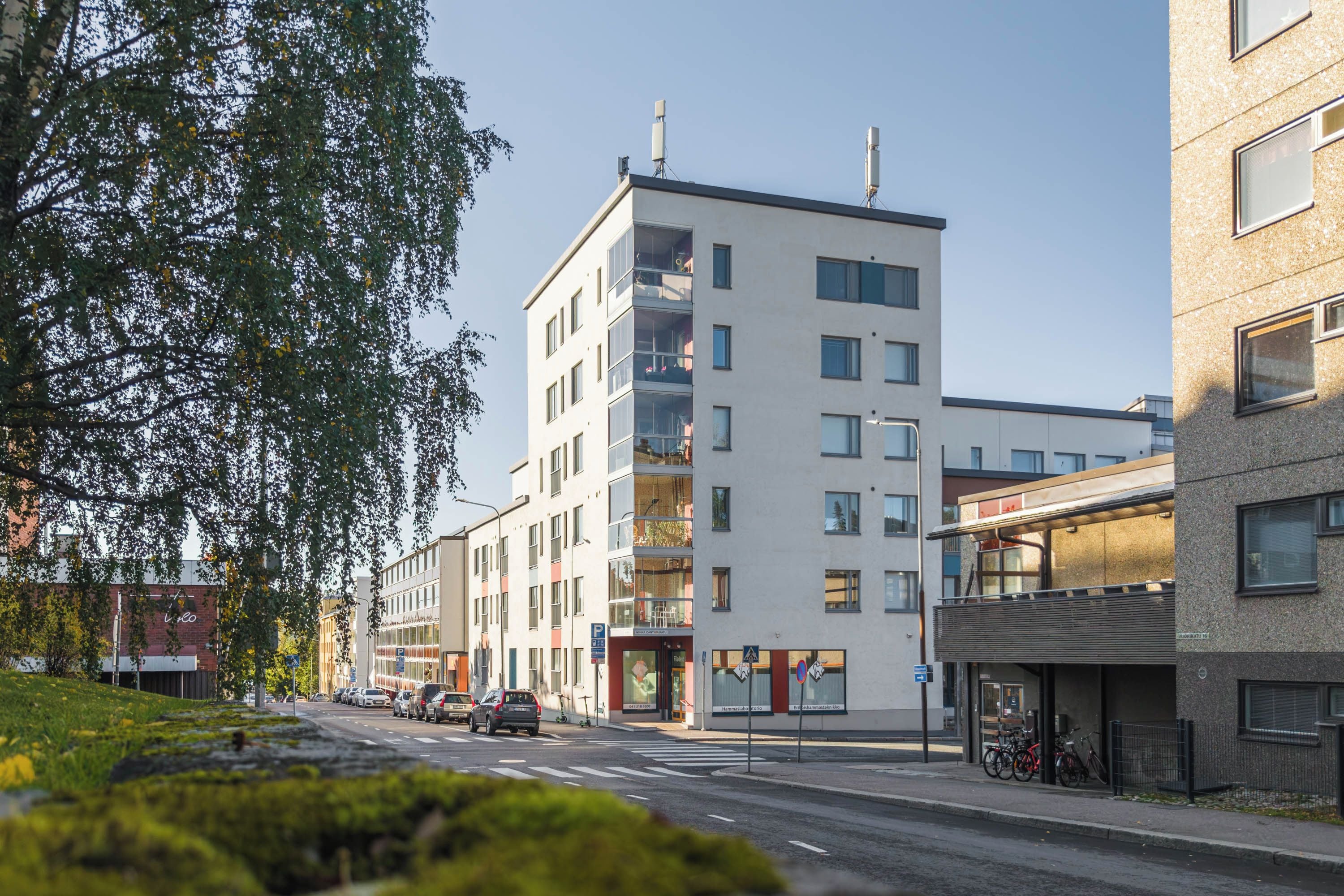 A multi-story building with a modern design, featuring a mix of glass and concrete facades.