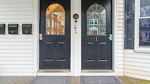 A double door with a black exterior, numbered 2A and 1, and a small window above the door.