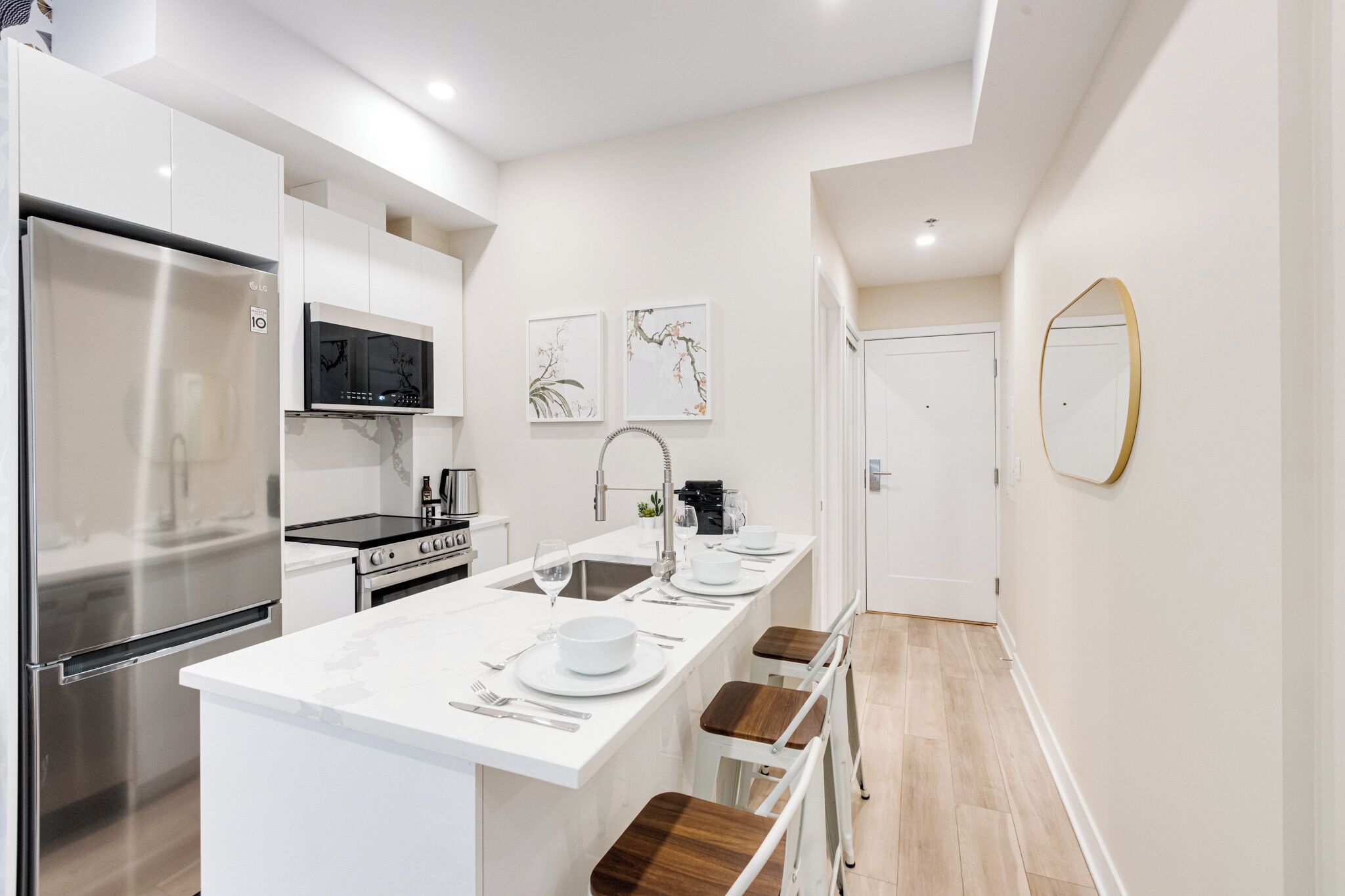 A modern kitchen with a central island, stainless steel appliances, and a minimalist design.