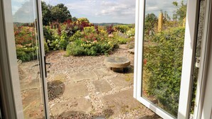 A garden with a stone pathway and a variety of colorful plants. - Balsaggart Farm (Maybole)