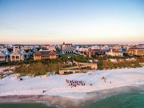 A coastal resort with beachfront villas, a boardwalk, and a sandy beach.