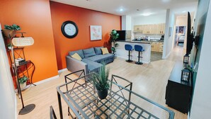 A modern apartment with a living room, kitchen, and dining area. - Convention Cent / 2 King Beds / 65" TV / Fireplace (Philadelphia)