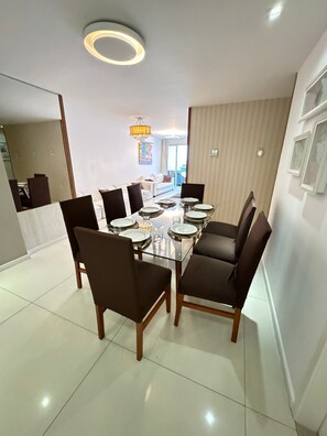 Deluxe Apartment, Lanai, Sea View | Living area | TV - PRAIA DO FORTE ALTO LUXO  (Cabo Frio)