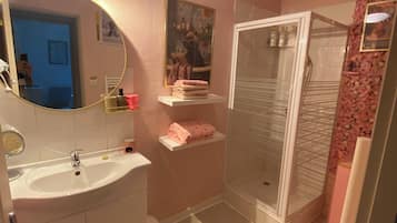 Shower, hair dryer, soap, toilet paper