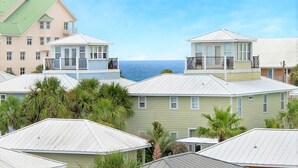A coastal residential area with multiple houses featuring balconies and a view of the ocean.