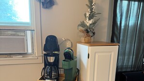 A kitchenette with a coffee maker, a toaster, a cabinet, and a small plant. - Lovely 2-bedroom home- pet friendly in Vanderbilt (Vanderbilt)