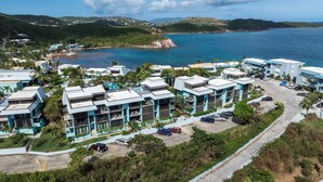 A coastal resort with modern buildings, a marina, and a clear view of the sea. - New central located 2BR/3BD/2BA condo gated community with 2 pools & pickleball (St Thomas)