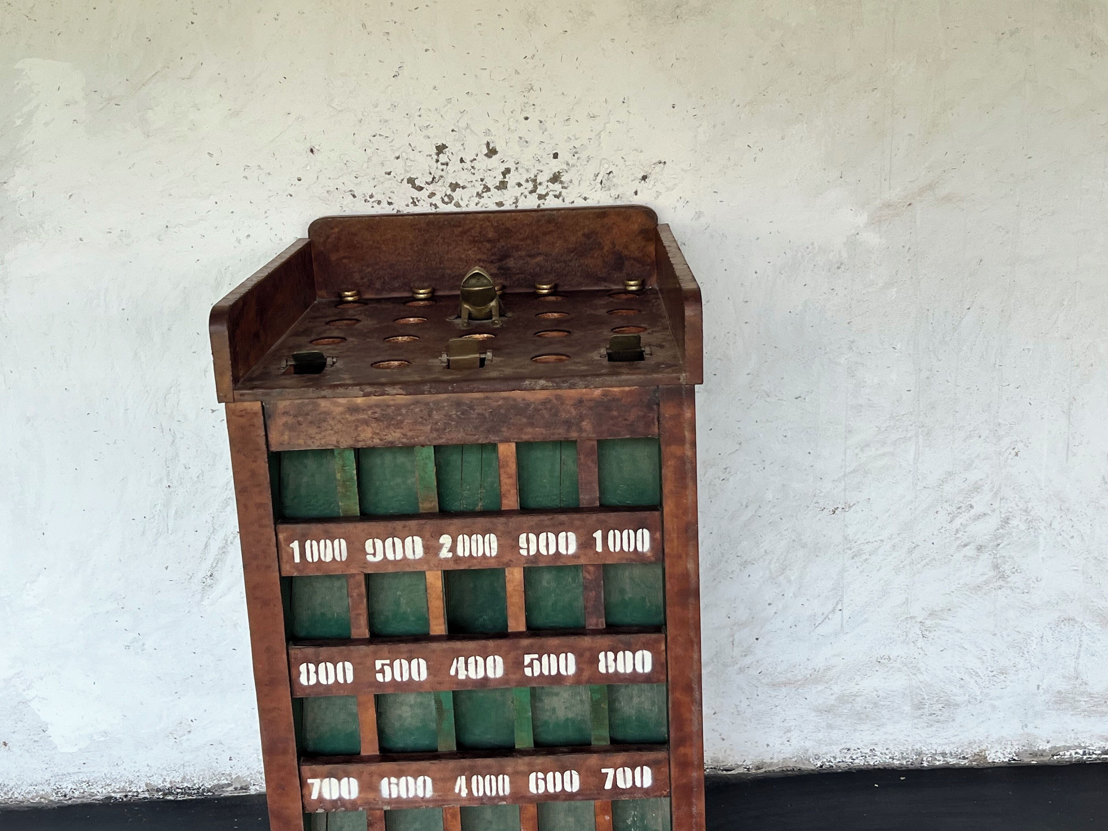 A vintage-style metal container with a grid of numbered compartments, likely used for storage or organization.
