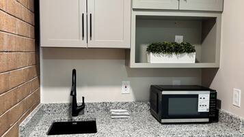 Fridge, microwave, coffee/tea maker, cookware/dishes/utensils