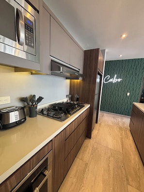 Fridge, microwave, oven, stovetop - Modern 2BR Condo, Stunning Rooftop Views in Cabo (Cabo San Lucas)