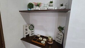 A shelf with decorative items including a sign that says "Home is where you plant it."