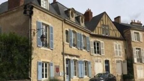 A row of traditional European-style houses with shuttered windows and a parked car on the street. - la  demeure de Laclais (Le Mans)