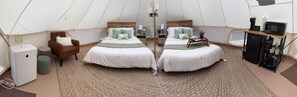 A tent with two beds, a chair, a small table, a refrigerator, and a microwave. - Secret Sycamore– Private Stargazing Glamping Tent with Fire Pit & Open Skies (Bunker)