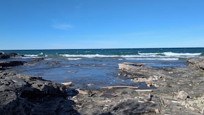 A rocky shoreline with waves crashing onto the rocks.