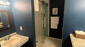 Shower, hair dryer, towels, shampoo