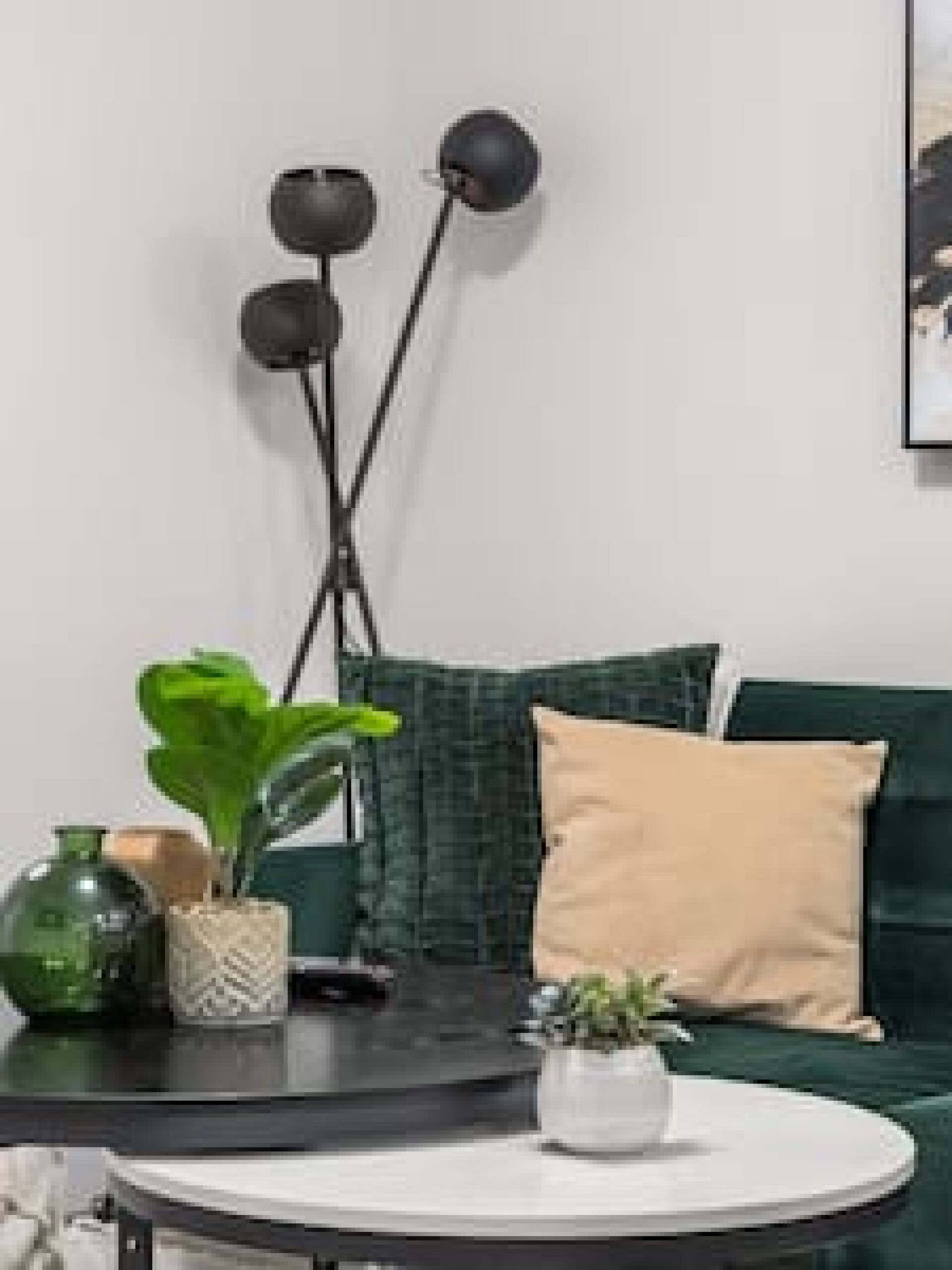 A modern living room with a green sofa, a round coffee table, and a floor lamp.
