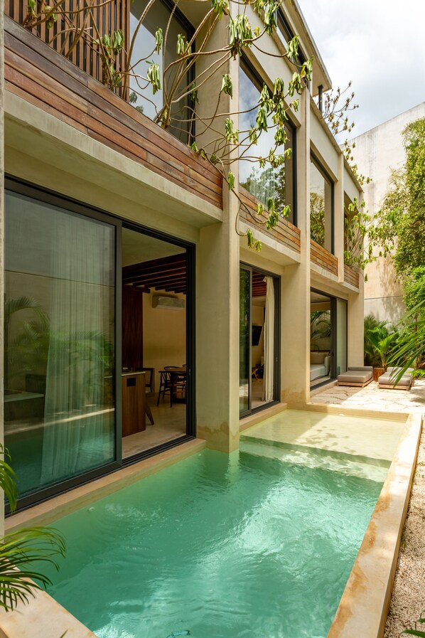 A modern house with a swimming pool, large windows, and wooden balconies.