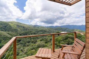 A wooden deck with a bench overlooking a lush green valley and distant mountains. - Apt w/ Fireplace, Jacuzzi, and Amazing View Vst027 (Anitapolis)