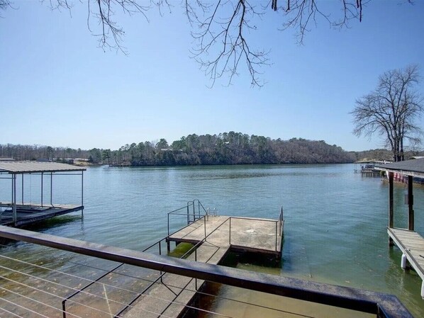 A lake with dock structures, including a covered area and a wooden pier.