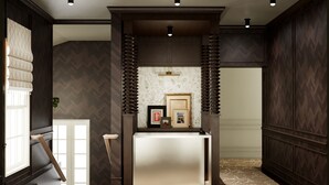 A reception area with a dark wood paneling, a reception desk, and framed pictures on the wall. - Cambridge Common House (Cambridge)