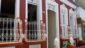 A red building with white decorative railings and numbered windows. - Pousada da Orla  (Itacaré)