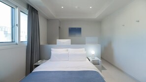 Premium bedding, desk, laptop workspace, soundproofing
