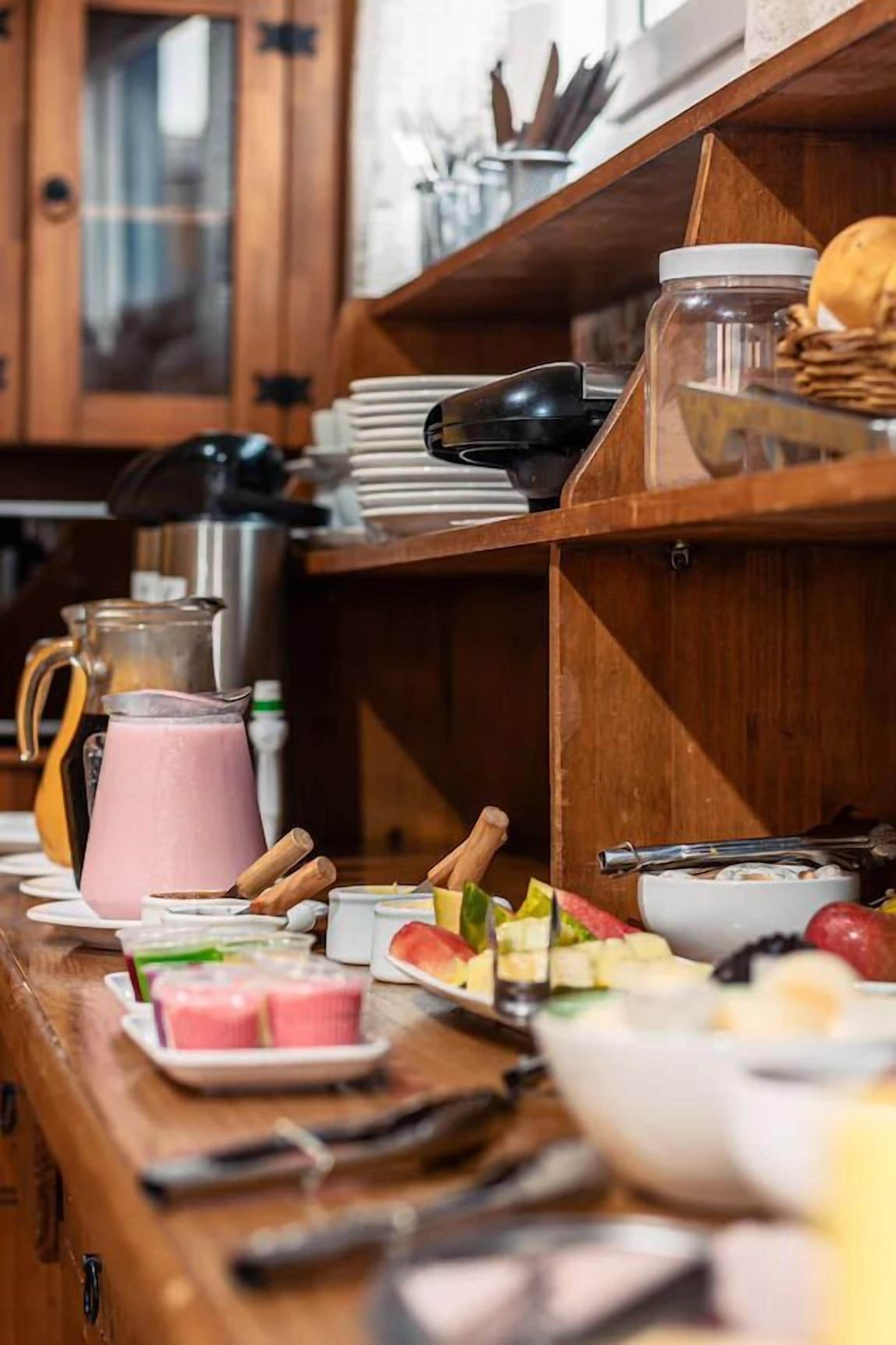 A breakfast buffet with various food items and a coffee station.