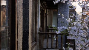 A traditional Japanese building with a wooden balcony and stone walls. - Sangzhu Kangzhu Luxury Residence (Deqin)