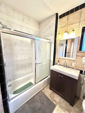 Shower, hair dryer, towels, soap