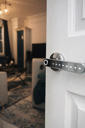 A modern door with a digital lock and a control panel with various symbols.
