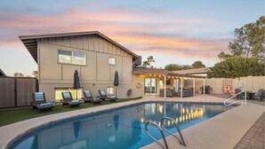 A swimming pool with lounge chairs and a covered patio area. - Old Town-6 BD + Heated Pool + Hot Tub + Game Room (Scottsdale)