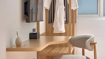 A modern bathroom with a wooden vanity, a mirror, and a towel rack.